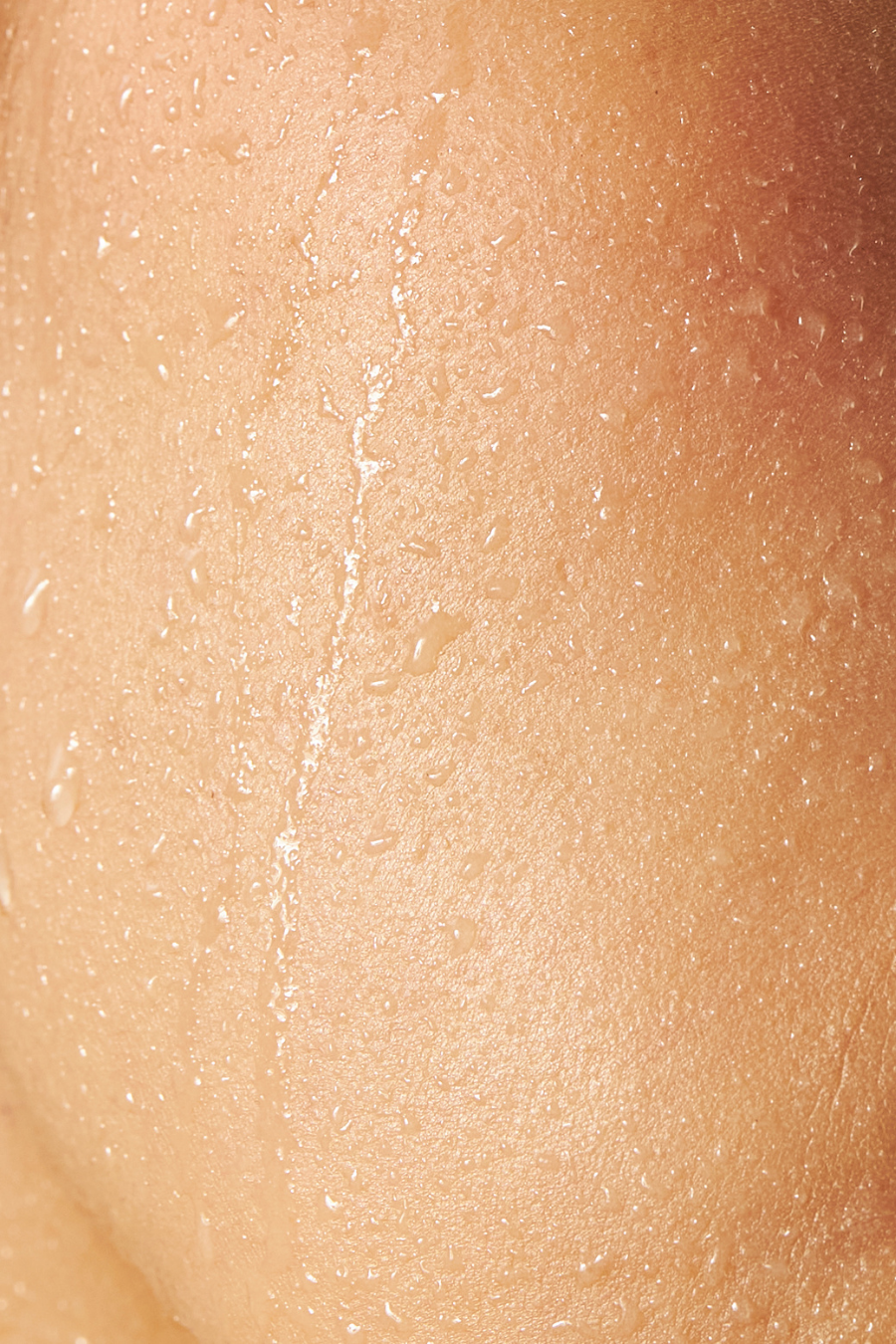 Close-up of hydrated skin with water droplets