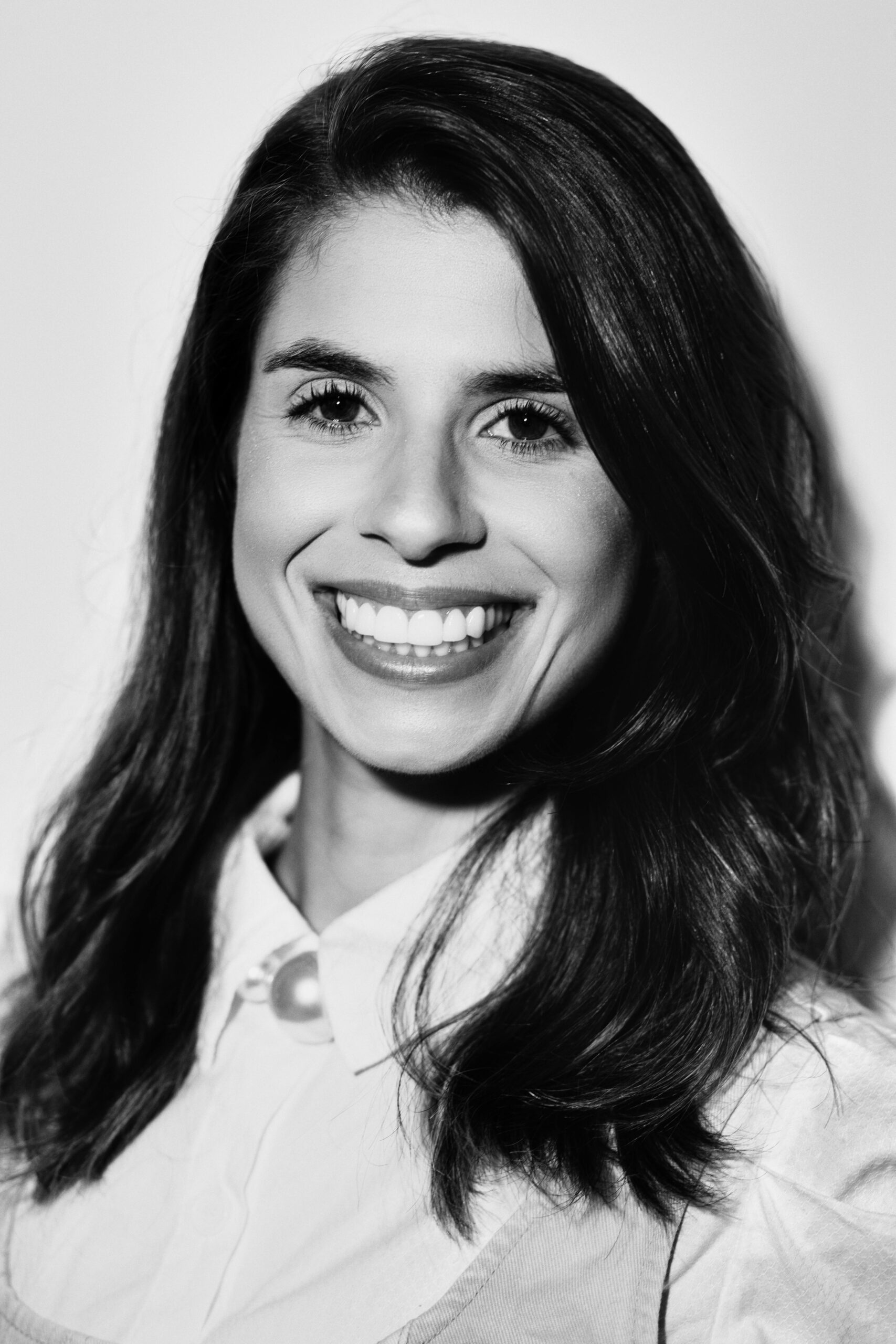 Woman smiling in a black-and-white portrait